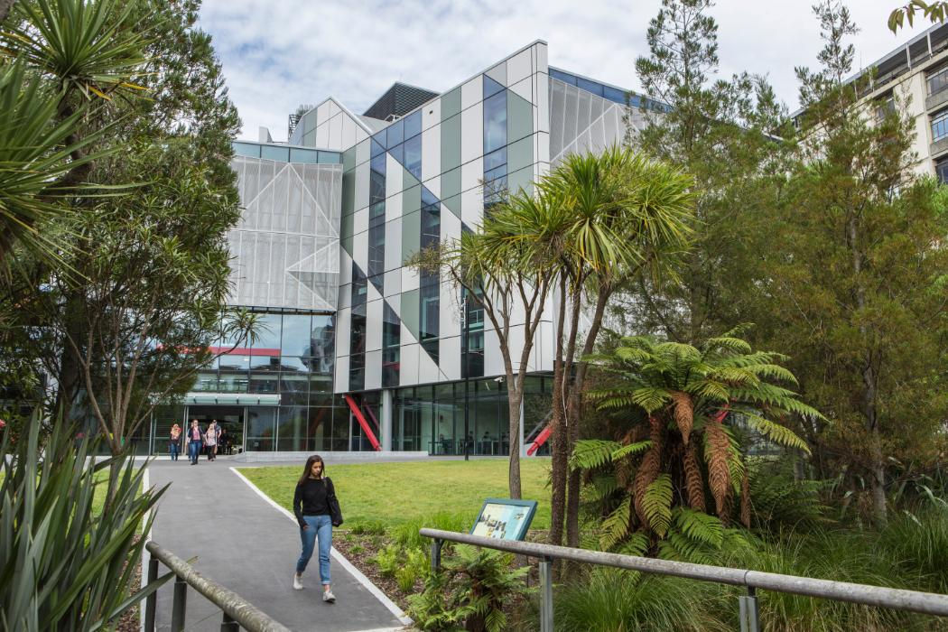 person walking in front of Ernest Rutherford building
