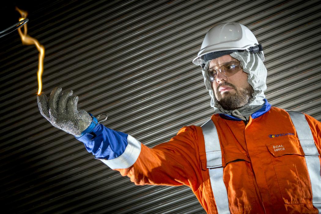 Man in safety gear demonstrates electrical arcing at UC Engineering 